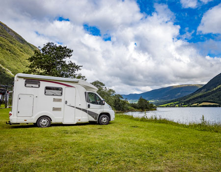 Motorhome parked for a family vacation trip, representing RV and caravan transport services for holiday travel across the U.S.