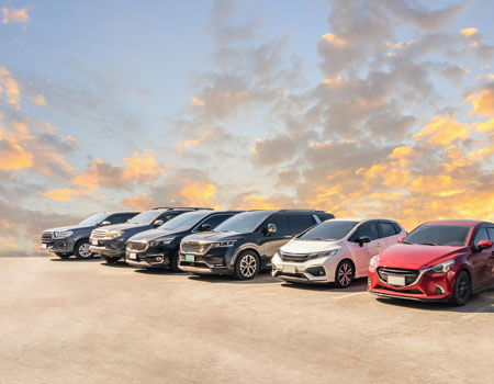Various types of cars parked in rows, showcasing vehicle diversity handled by Safe Car Hauler across the U.S.